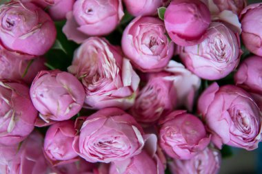 Backdrop of colorful paper roses background in a wedding reception with soft colors.