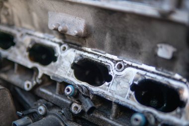 Close up of dirty intake manifold ports. Engine cleaning process the intake manifold. Car repair concept. dirty engine Intake car engine Close up manifold ports. Dirty intake manifold.