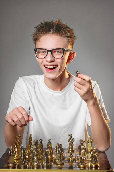boy playing chess in the studio