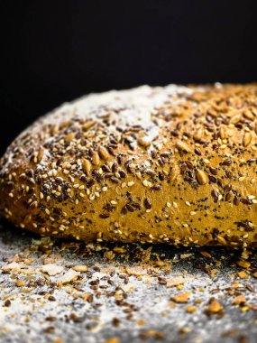 Ev yapımı çavdar ekmeği üzerine semya serpiştirilmiş siyah arka plan yakın görünüm