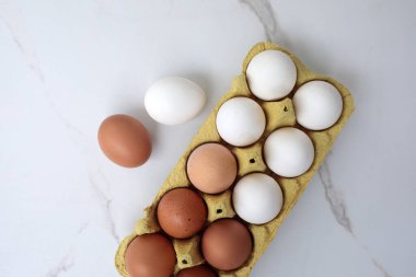 Beyaz arka planda yumurta tepsisine çiğ tavuk yumurtası yakın plan. Karton tepside bir grup taze beyaz yumurta. Organik gıda doğası gereği sağlıklıdır.