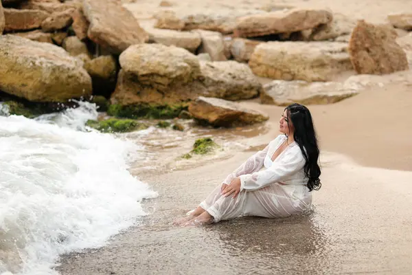 Yazın beyaz elbiseli güzel bir kız kumsalda kumsalda.