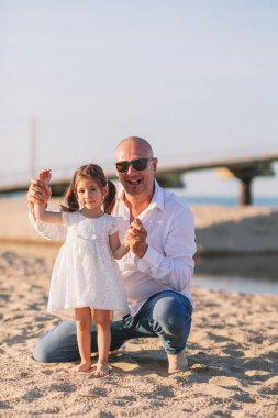 Babam yazın deniz sahilinde kızıyla oynar. Babalar Günü..