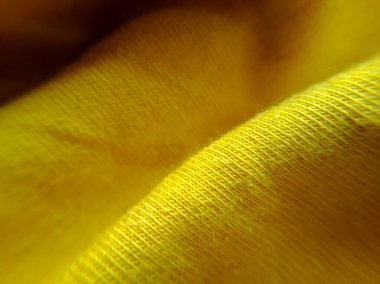 Sarı kumaş, arkaplan ve dokunun yakın plan görüntüsü