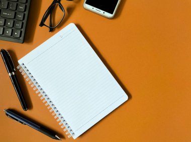 Açık kahverengi arka planda minimal çalışma alanı kurulumu. 