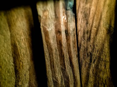 Rough wooden planks are closely arranged, showcasing a detailed texture.