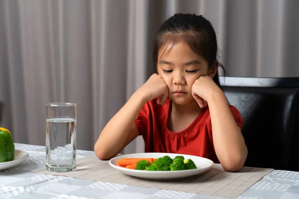 stock image Little cute kid girl refusing to eat healthy vegetables. Children do not like to eat vegetables.