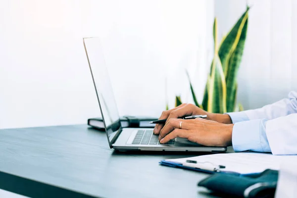 stock image Doctor was sitting in the office working on a laptop computer.