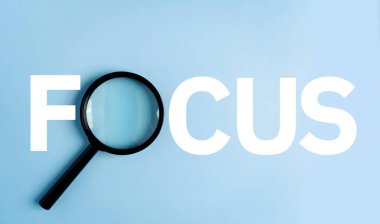 A magnifying glass on the floor shows the word FOCUS. clipart