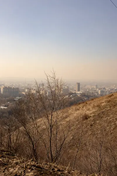 Barren Hillside 'dan Hazy City