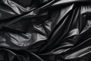 Siyah selofan çöp torbası dokusunun işlenmiş kolajı. Pankart, arkaplan veya 3B haritalama için doku