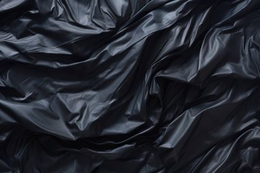 Siyah selofan çöp torbası dokusunun işlenmiş kolajı. Pankart, arkaplan veya 3B haritalama için doku