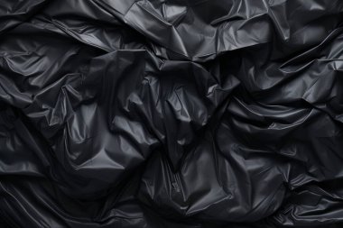 Siyah selofan çöp torbası dokusunun işlenmiş kolajı. Pankart, arkaplan veya 3B haritalama için doku