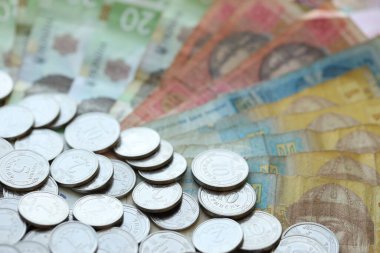 Ukraine money coins lying on mixed hryvnia banknotes, background. finance concept