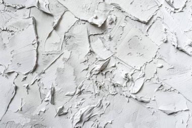 Kabuğu soyulmuş beyaz alçı duvarın fotoğrafı. Arkaplan veya haritalama için arkaplan dokusu