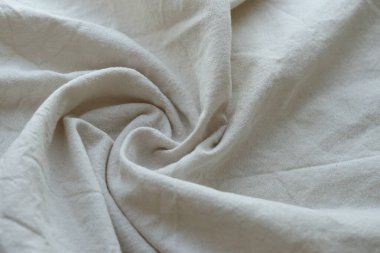 Arka plan olarak beyaz renkli gri tekstil peçetesi. Katlanmış dekoratif mutfak pamuğu havlusu kapat.