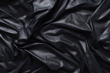 Siyah selofan çöp torbası dokusunun işlenmiş kolajı. Pankart, arkaplan veya 3B haritalama için doku