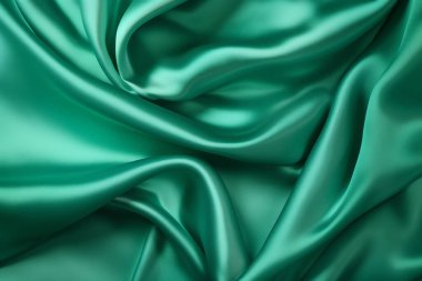 Zümrüt yeşili ipek yüzey dokusunun işlenmiş kolajı. Pankart, arkaplan veya 3B haritalama için doku