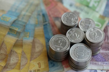Birkaç yığın Ukrayna parası eski Hryvnia banknotlarının üzerinde yatıyor.