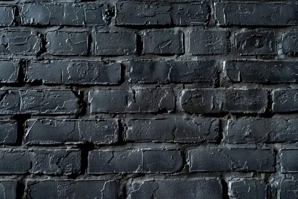 Eski tuğla duvarın resmi siyah renge boyanmış. Yakın plan. Arkaplan veya haritalama için arkaplan dokusu