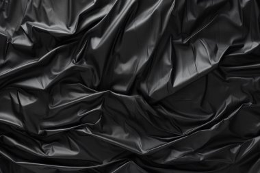 Siyah selofan çöp torbası dokusunun işlenmiş kolajı. Pankart, arkaplan veya 3B haritalama için doku