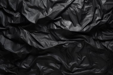 Siyah selofan çöp torbası dokusunun işlenmiş kolajı. Pankart, arkaplan veya 3B haritalama için doku
