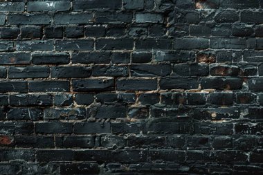 Eski getto siyah tuğla duvarının fotoğrafı. Arkaplan veya haritalama için arkaplan dokusu