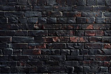 Eski getto siyah tuğla duvarının fotoğrafı. Arkaplan veya haritalama için arkaplan dokusu