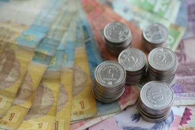 Birkaç yığın Ukrayna parası eski Hryvnia banknotlarının üzerinde yatıyor.
