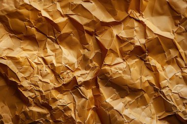 Buruşuk kahverengi kağıdın fotoğrafı. Kapatın. Arkaplan veya haritalama için arkaplan dokusu