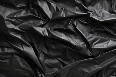 Siyah selofan çöp torbası dokusunun işlenmiş kolajı. Pankart, arkaplan veya 3B haritalama için doku