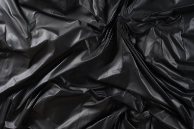 Siyah selofan çöp torbası dokusunun işlenmiş kolajı. Pankart, arkaplan veya 3B haritalama için doku