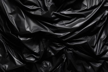 Siyah selofan çöp torbası dokusunun işlenmiş kolajı. Pankart, arkaplan veya 3B haritalama için doku