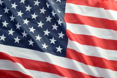 Amerika Birleşik Devletleri bayrağı, yıldız ve şeritlerle kaplıdır. Resmi Amerikan Bayrağı gün ışığında kıvrımlarla el sallıyor