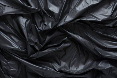 Siyah selofan çöp torbası dokusunun işlenmiş kolajı. Pankart, arkaplan veya 3B haritalama için doku