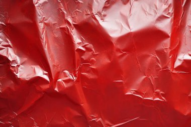İşlenmiş kırmızı plastik selofan yüzey dokusu kolajı. Pankart, arkaplan veya 3B haritalama için doku