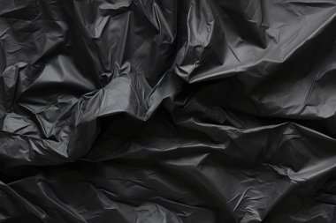 Siyah selofan çöp torbası dokusunun işlenmiş kolajı. Pankart, arkaplan veya 3B haritalama için doku