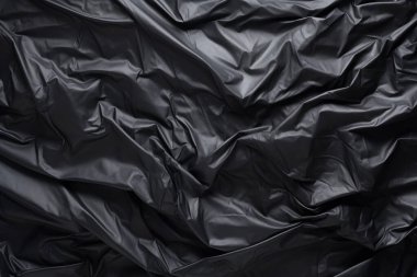 Siyah selofan çöp torbası dokusunun işlenmiş kolajı. Pankart, arkaplan veya 3B haritalama için doku