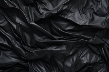 Siyah selofan çöp torbası dokusunun işlenmiş kolajı. Pankart, arkaplan veya 3B haritalama için doku