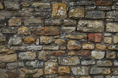 Eski gri ve kahverengi taş duvarın fotoğrafı. Arkaplan veya haritalama için arkaplan dokusu