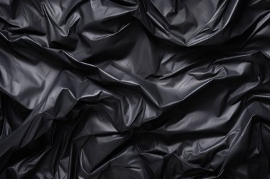 Siyah selofan çöp torbası dokusunun işlenmiş kolajı. Pankart, arkaplan veya 3B haritalama için doku