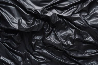 Siyah selofan çöp torbası dokusunun işlenmiş kolajı. Pankart, arkaplan veya 3B haritalama için doku