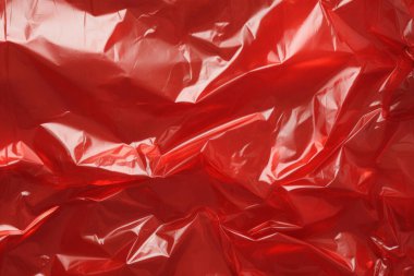 İşlenmiş kırmızı plastik selofan yüzey dokusu kolajı. Pankart, arkaplan veya 3B haritalama için doku