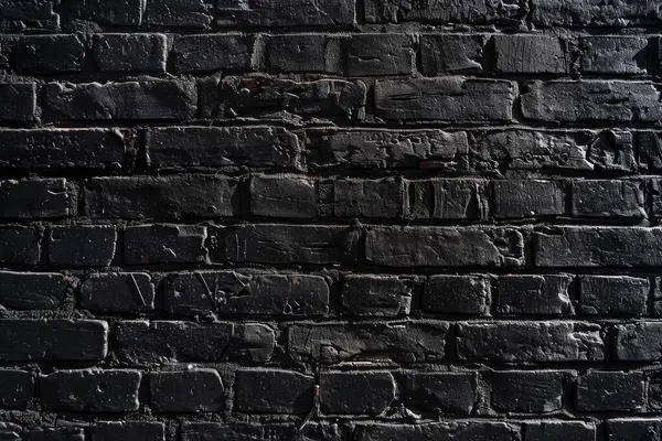 Eski tuğla duvarın resmi siyah renge boyanmış. Yakın plan. Arkaplan veya haritalama için arkaplan dokusu