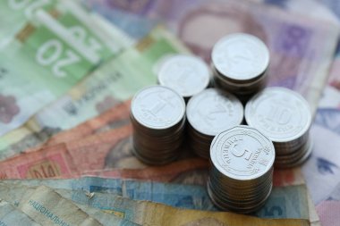 Birkaç yığın Ukrayna parası eski Hryvnia banknotlarının üzerinde yatıyor.