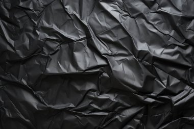 Siyah selofan çöp torbası dokusunun işlenmiş kolajı. Pankart, arkaplan veya 3B haritalama için doku