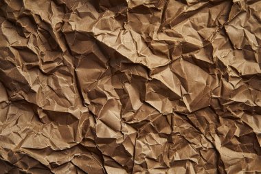 Buruşuk kahverengi kağıdın fotoğrafı. Kapatın. Arkaplan veya haritalama için arkaplan dokusu