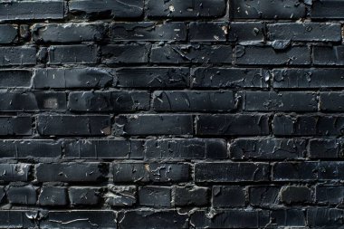 Eski tuğla duvarın resmi siyah renge boyanmış. Yakın plan. Arkaplan veya haritalama için arkaplan dokusu