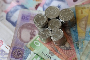 Birkaç yığın Ukrayna parası eski Hryvnia banknotlarının üzerinde yatıyor.