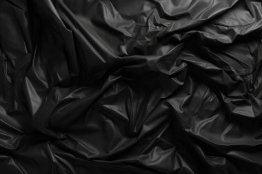 Siyah selofan çöp torbası dokusunun işlenmiş kolajı. Pankart, arkaplan veya 3B haritalama için doku